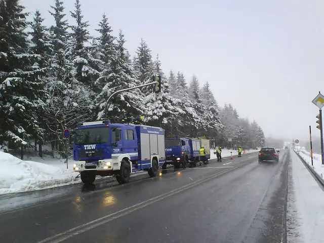 In this picture I can see cone bar barricades, vehicles on the road, there are group of people ,...