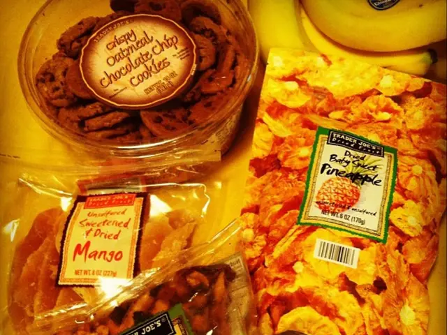 In this picture there food items in the covers and in the boxes and there are labels on the covers...